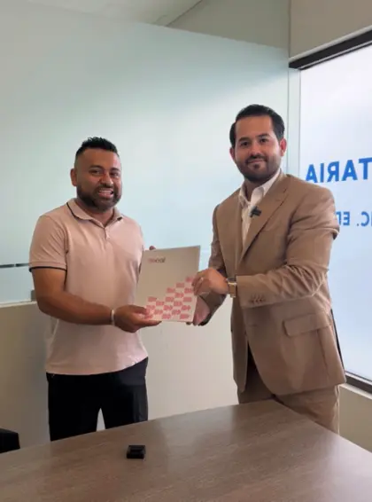 Cliente y equipo de Casas DEAL con la carpeta de firma.